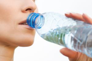 Woman drinking water at outdoors sport